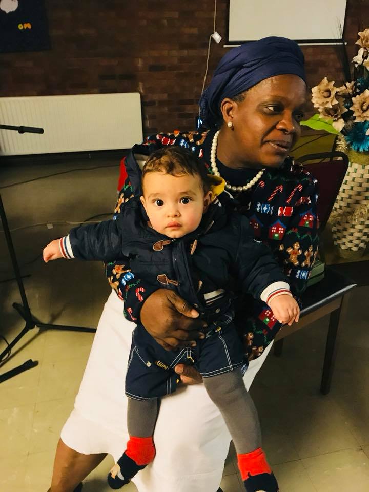 Pastor Laditi holding baby